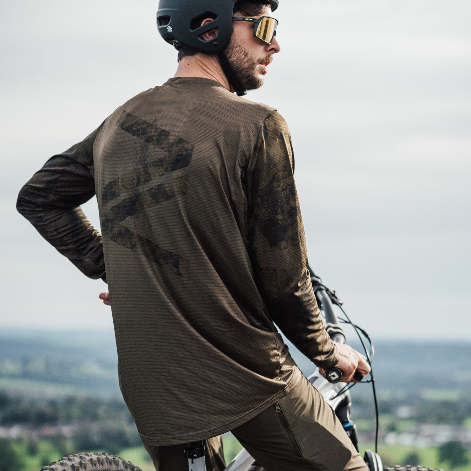 Durable and stretchy khaki long sleeve jersey for enduro and downhill mountain biking, with a sustainable design