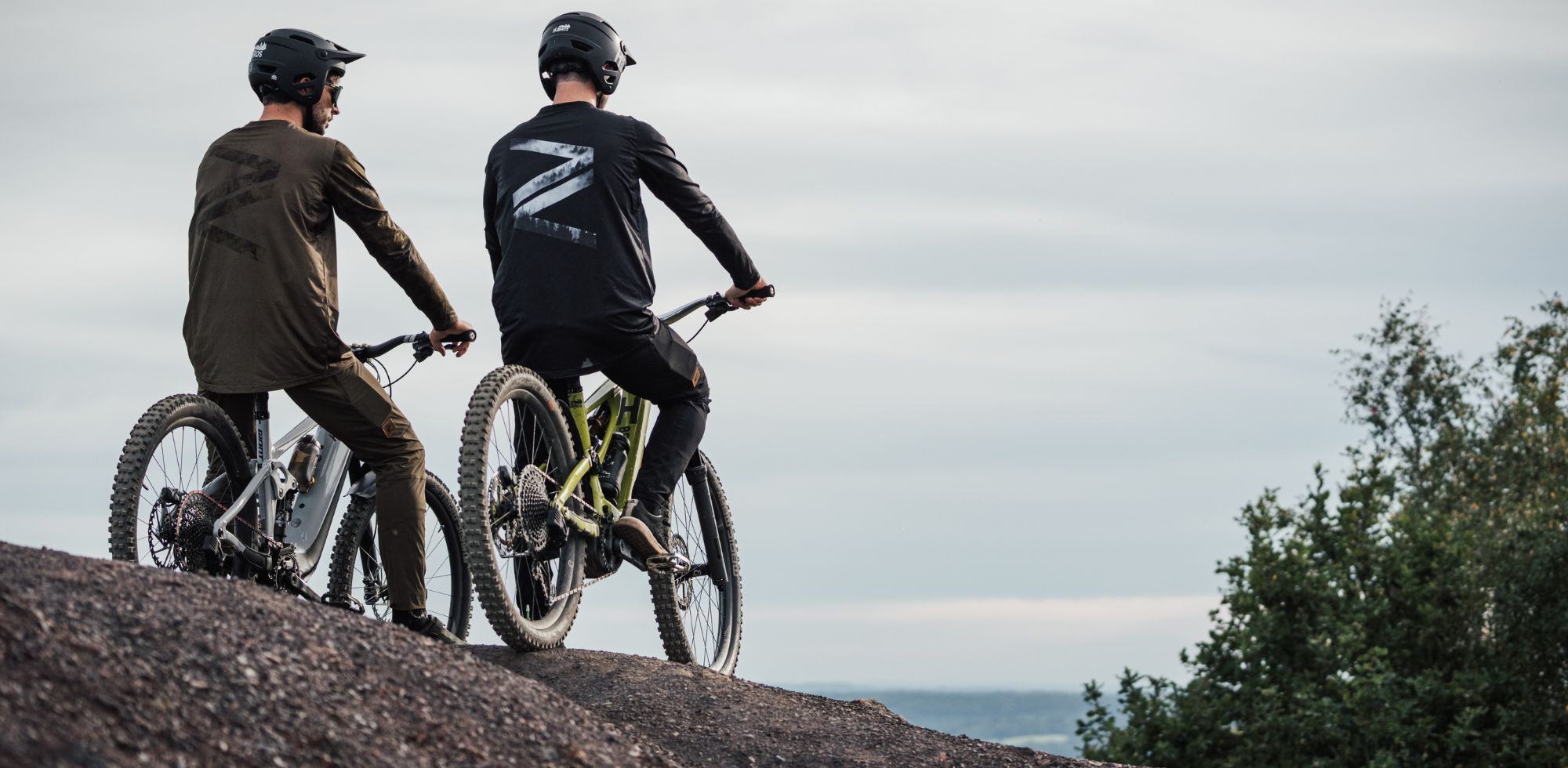 2 mountain bike riders on top of a trail